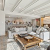  A modern living room with a wooden coffee table and a white sofa.