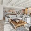  A modern living room with a wooden coffee table and a white sofa.
