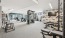  A gym with a variety of equipment including weights, benches, and a television.