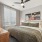  A bedroom with a large bed and a ceiling fan.