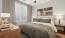  A bedroom with a large bed and a ceiling fan.