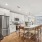  A modern kitchen with a large island and wooden floors.