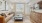  A living room with a brown leather couch, a coffee table, and a painting on the wall.