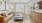  A living room with a brown leather couch, a coffee table, and a painting on the wall.