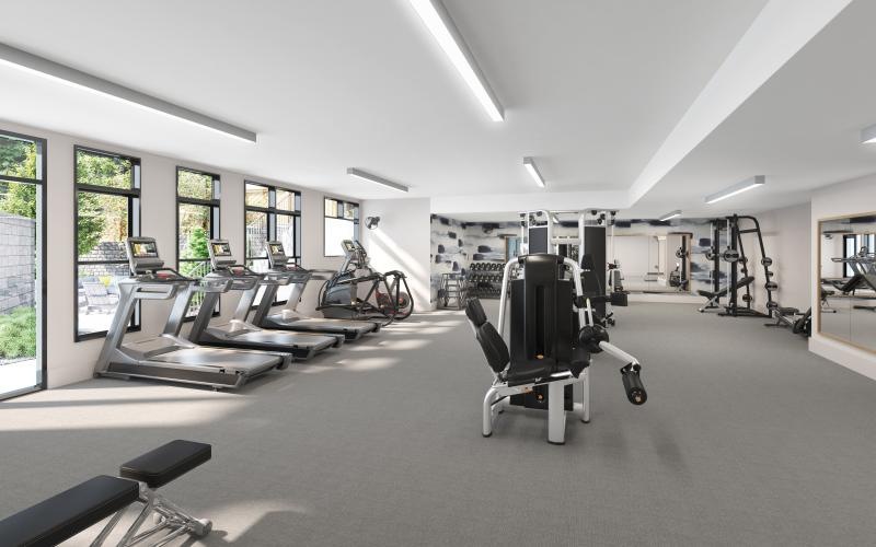 a room with exercise equipment and windows